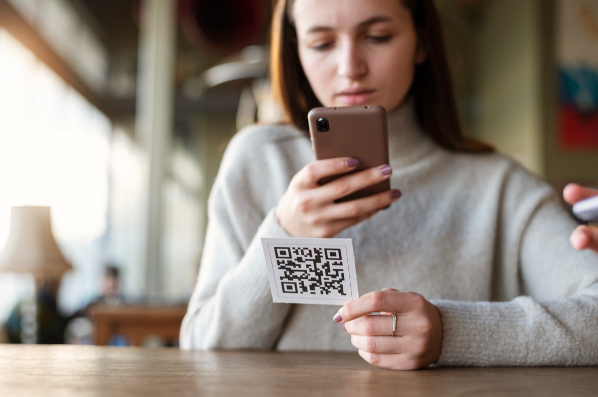 Person scanning a QR code with a smartphone