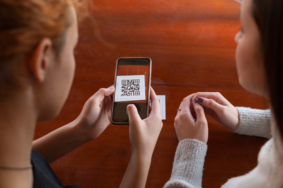 QR code on a printed poster being scanned